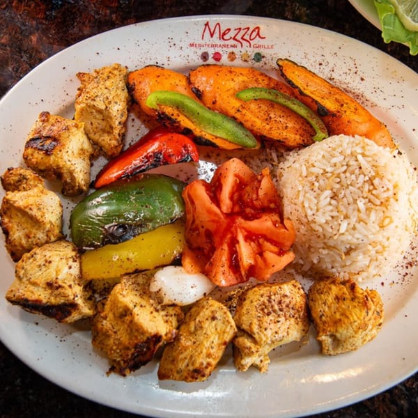 Mezza Mediterranean Grille's chicken shish tawook with grilled vegetables, rice, and tomatoes.